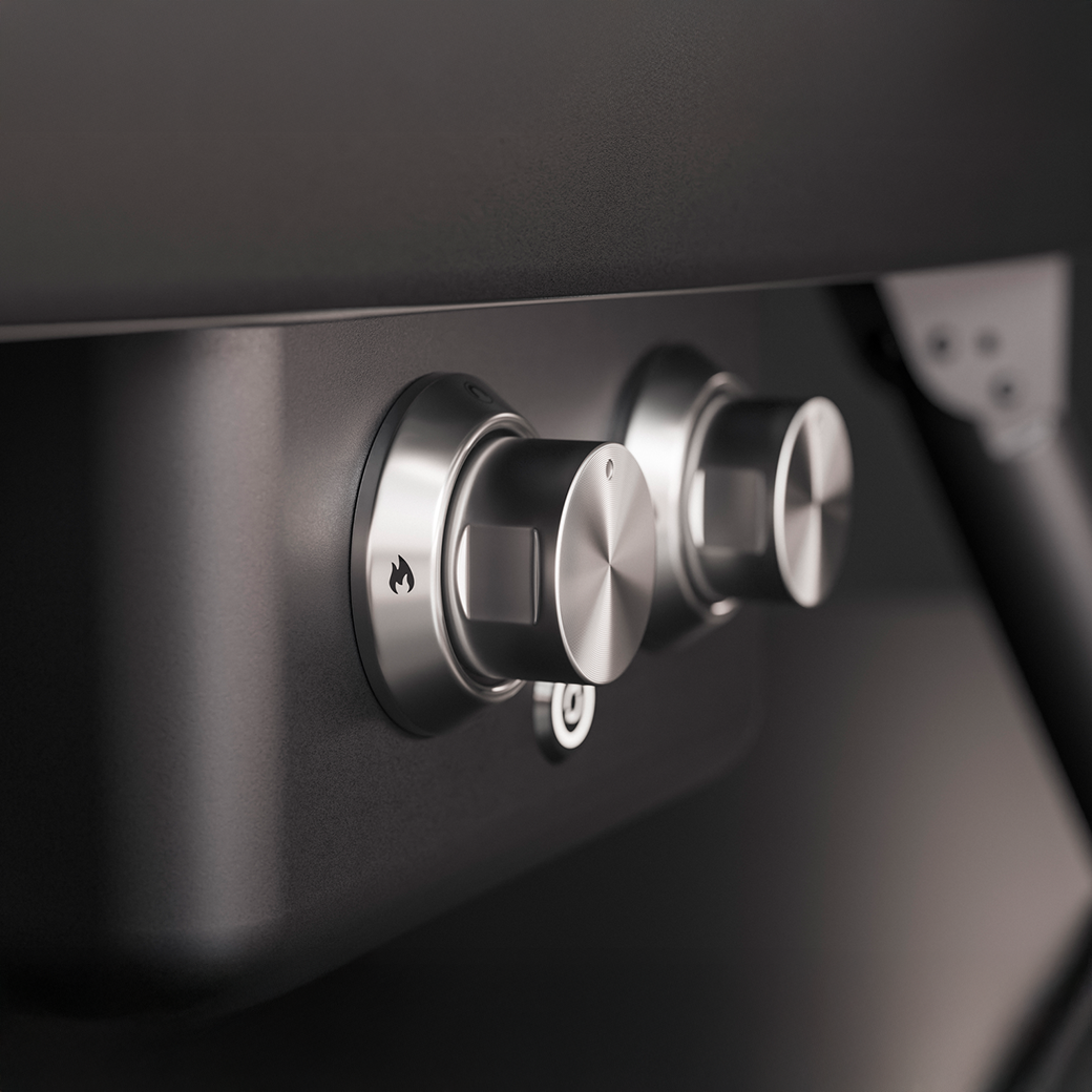 Close-up of metallic control knobs on a black surface