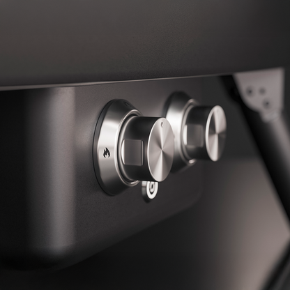 Close-up of metallic control knobs on a black surface